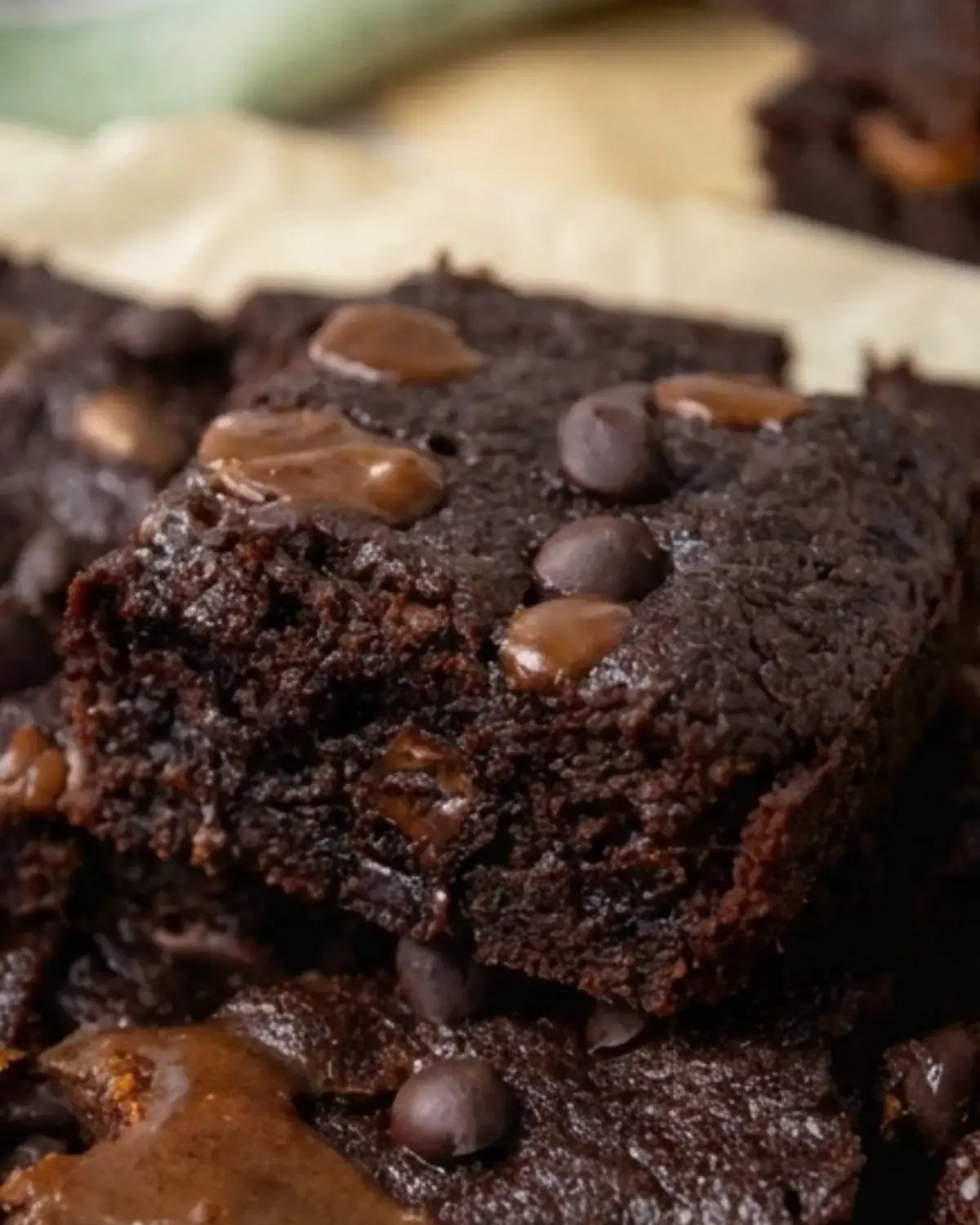Close-up of a fudgy protein brownie studded with melted chocolate chips