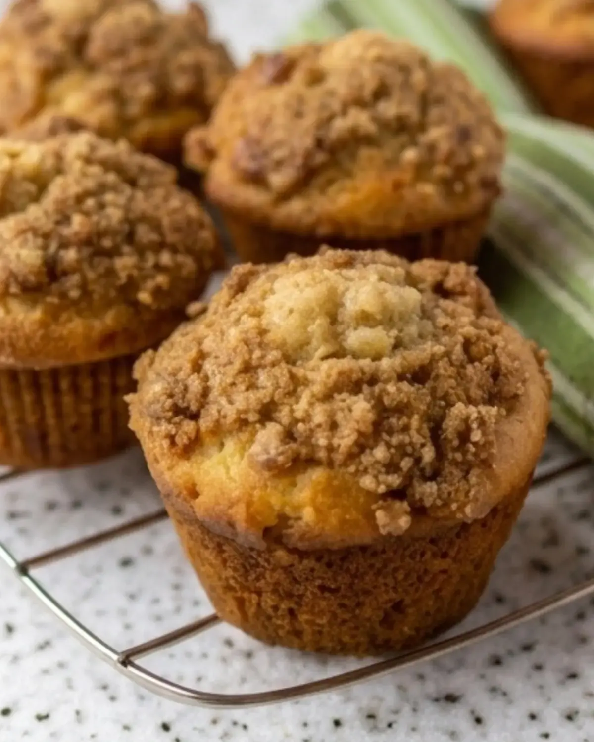 Close-up of cinnamon streusel muffins with a thick golden crumb topping